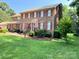 Two story brick home with shutters, lovely front lawn and attached garage at 8432 Junction Ct, Charlotte, NC 28215