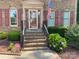 Inviting front porch with brick steps and black railings, leading to a glass-paneled front door at 8432 Junction Ct, Charlotte, NC 28215