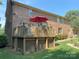 A spacious back deck with a red umbrella, perfect for outdoor relaxation at 8432 Junction Ct, Charlotte, NC 28215