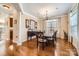 Bright dining room features hardwood floors, elegant chandelier, and large windows, offering ample natural light at 8436 Summerford Dr, Charlotte, NC 28269