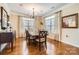 Dining room features hardwood floors, natural light, chandelier, and a wooden table with chairs at 8436 Summerford Dr, Charlotte, NC 28269