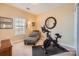 Dedicated exercise room with stationary bike, zebra chaise, and natural light, perfect for fitness at 8436 Summerford Dr, Charlotte, NC 28269