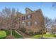 Brick townhome featuring manicured lawn, trimmed shrubs, and stairs leading to the entrance at 8436 Summerford Dr, Charlotte, NC 28269