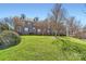 Brick townhomes with lush green lawn and mature trees creating a charming curb appeal at 8436 Summerford Dr, Charlotte, NC 28269