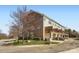 Exterior shot of townhomes featuring brick and siding, with attached garages and small decks at 8436 Summerford Dr, Charlotte, NC 28269