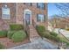 Exterior entrance with brick steps, iron railings, and manicured shrubs creating an inviting entry at 8436 Summerford Dr, Charlotte, NC 28269