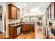 Kitchen with wooden cabinets, granite countertops, stainless appliances, and hardwood floors at 8436 Summerford Dr, Charlotte, NC 28269