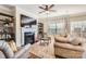 Living room featuring fireplace, TV, hardwood floors, and elegant furniture at 8436 Summerford Dr, Charlotte, NC 28269