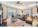 Living room area features hardwood floors, a fireplace, and views into kitchen and dining area at 8436 Summerford Dr, Charlotte, NC 28269