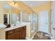 Modern main bathroom with glass-enclosed shower, single vanity, and ample lighting at 8436 Summerford Dr, Charlotte, NC 28269