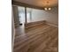 Dining room featuring wood floors, chandelier and partial view of the living room at 9037 J M Keynes Dr, Charlotte, NC 28262