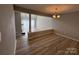 Dining room featuring wood floors, chandelier and partial view of the living room at 9037 J M Keynes Dr, Charlotte, NC 28262