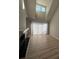 Bright and airy living room featuring wood floors, a fireplace, and a large window for natural light at 9037 J M Keynes Dr, Charlotte, NC 28262