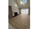 Bright living room featuring wood floors, a black-tiled fireplace, built in shelving and vaulted ceilings at 9037 J M Keynes Dr, Charlotte, NC 28262