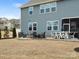 Backyard view featuring a patio with fire pit and outdoor furniture, along with a screened-in porch for outdoor relaxation at 925 Deep River Way, Waxhaw, NC 28173