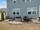 Backyard view featuring a brick fire pit and Adirondack chairs, ideal for outdoor gatherings and cozy evenings at 925 Deep River Way, Waxhaw, NC 28173