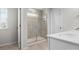 Modern bathroom showcasing a tiled shower with glass doors, complemented by a sleek vanity and fixtures at 925 Deep River Way, Waxhaw, NC 28173