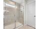 Bathroom featuring a shower with a glass enclosure, tiled walls, and a built-in seat for added comfort at 925 Deep River Way, Waxhaw, NC 28173