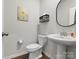 Bathroom featuring a pedestal sink and a sunflower wall painting at 925 Deep River Way, Waxhaw, NC 28173