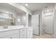 Bathroom featuring a dual vanity, bright lighting, and a glass-enclosed shower, designed for modern living at 925 Deep River Way, Waxhaw, NC 28173