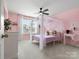 Pink bedroom featuring canopy bed and bright natural light at 925 Deep River Way, Waxhaw, NC 28173