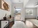 Bright foyer with hardwood floors, an elegant table and a view looking out to the neighborhood at 925 Deep River Way, Waxhaw, NC 28173