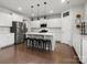 Bright kitchen featuring stainless steel appliances, a large island, and bar stool seating at 925 Deep River Way, Waxhaw, NC 28173