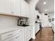 A bright and clean kitchenette in white, featuring modern appliances and ample counter space at 925 Deep River Way, Waxhaw, NC 28173