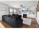 Cozy living room features a fireplace, a large sofa, hardwood floors, and bright windows at 925 Deep River Way, Waxhaw, NC 28173