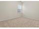 Empty bedroom featuring neutral walls, plush carpet and a window allowing natural light at 966 Parkland Nw Pl, Concord, NC 28027