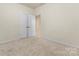 Neutral bedroom with carpet, white trim, and walk in closet at 966 Parkland Nw Pl, Concord, NC 28027