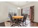 Bright dining area featuring a table with four chairs, big window, and access to the outside at 966 Parkland Nw Pl, Concord, NC 28027