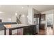 Open concept kitchen with an island, stainless steel refrigerator and dark wood cabinets at 966 Parkland Nw Pl, Concord, NC 28027