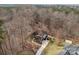 Stunning aerial shot exhibiting the home's layout, driveway, and landscaping against a backdrop of dense trees at 109 Hawksnest Ln, Mooresville, NC 28117