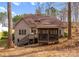 The backyard features a multi-level deck with stairs, complemented by a screened gazebo, nestled within the wooded landscape at 109 Hawksnest Ln, Mooresville, NC 28117