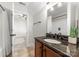 Bathroom with single sink vanity with granite countertop and tiled floors at 109 Hawksnest Ln, Mooresville, NC 28117