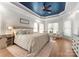 Spacious bedroom with tray ceiling, a sitting area, and hardwood floors at 109 Hawksnest Ln, Mooresville, NC 28117