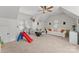 Large bonus room is carpeted, has a ceiling fan, and is perfect for entertaining at 109 Hawksnest Ln, Mooresville, NC 28117