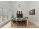 Bright dining room featuring hardwood floors, a fireplace, modern lighting, and a large window at 109 Hawksnest Ln, Mooresville, NC 28117