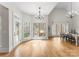 Bright dining room with many windows, wood floors, and modern chandelier at 109 Hawksnest Ln, Mooresville, NC 28117