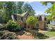 Traditional home exterior with stone and siding, a neatly landscaped yard and pathway to the front door, and mature trees at 109 Hawksnest Ln, Mooresville, NC 28117
