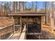 The screened gazebo features a charming design and wooden walkway, perfect for outdoor relaxation, set within a wooded landscape at 109 Hawksnest Ln, Mooresville, NC 28117
