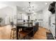 Bright kitchen features an island with seating, white cabinets, and stainless steel appliances at 109 Hawksnest Ln, Mooresville, NC 28117
