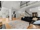 Bright living room with a black fireplace, large sectional, hardwood floors and access to the kitchen at 109 Hawksnest Ln, Mooresville, NC 28117
