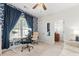 Well-lit office with blue wallpaper, a large window with natural light, and a comfortable chair at 109 Hawksnest Ln, Mooresville, NC 28117