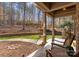 Inviting front porch with stone accents, large columns, seating and views of the backyard with mature trees at 109 Hawksnest Ln, Mooresville, NC 28117