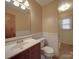 Neat bathroom with a wood vanity, standard toilet, and a bright, sunlit window at 1120 Glenarden Dr, Rock Hill, SC 29730