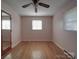 Simple bedroom features hardwood floors, ceiling fan, and ample natural light from windows at 1120 Glenarden Dr, Rock Hill, SC 29730