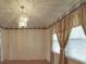 Charming dining area with an elegant chandelier, classic wallpaper, and natural light from the window at 1120 Glenarden Dr, Rock Hill, SC 29730