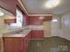 Traditional kitchen featuring red cabinetry, updated countertops, and resilient flooring at 1120 Glenarden Dr, Rock Hill, SC 29730